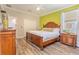 Comfortable bedroom showcasing a wooden bed frame, natural light, and closet at 2985 Buccaneer Palm Rd, Kissimmee, FL 34747