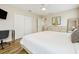Bright bedroom featuring a queen bed, closet, desk and neutral decor at 2985 Buccaneer Palm Rd, Kissimmee, FL 34747