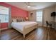 Inviting bedroom with a large bed, wood floors, neutral walls, and abundant natural light at 2985 Buccaneer Palm Rd, Kissimmee, FL 34747