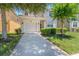 Inviting home with a lush green lawn and a spacious driveway at 2985 Buccaneer Palm Rd, Kissimmee, FL 34747