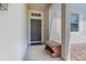 Welcoming front porch featuring tiled flooring and a stylish bench at 2985 Buccaneer Palm Rd, Kissimmee, FL 34747
