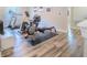 Home gym with modern exercise equipment, wood floors and natural lighting at 2985 Buccaneer Palm Rd, Kissimmee, FL 34747