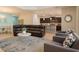 Open-concept living room featuring comfortable seating and an adjacent kitchen at 2985 Buccaneer Palm Rd, Kissimmee, FL 34747
