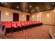 Comfortable seating inside the community movie theater with plush, red chairs at 2985 Buccaneer Palm Rd, Kissimmee, FL 34747