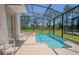 Relaxing private screened-in pool area with a spillover spa for outdoor enjoyment at 2985 Buccaneer Palm Rd, Kissimmee, FL 34747