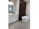Stylish bathroom showcasing a soaking tub, wood accent wall, double sink vanity, and gray tile flooring at 3063 Sw 168Th Loop, Ocala, FL 34473