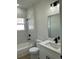 Updated bathroom featuring a shower-tub combo with marble-look tile and modern black fixtures at 3063 Sw 168Th Loop, Ocala, FL 34473
