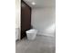 Modern bathroom features a standalone tub and wooden plank accent wall at 3063 Sw 168Th Loop, Ocala, FL 34473