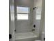 Bathroom featuring a shower-tub combo with marble-look tile and modern black fixtures at 3063 Sw 168Th Loop, Ocala, FL 34473