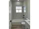 Bathroom featuring a shower-tub combo with marble-look tile and modern black fixtures at 3063 Sw 168Th Loop, Ocala, FL 34473