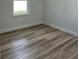 A bright bedroom with light wood-look flooring and a window at 3063 Sw 168Th Loop, Ocala, FL 34473