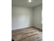 A clean, empty bedroom features new wood-look flooring and light grey walls at 3063 Sw 168Th Loop, Ocala, FL 34473