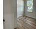 A bedroom features new floors and a window with a view of the outdoors at 3063 Sw 168Th Loop, Ocala, FL 34473