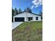 Charming single-story home features a black garage door and a well-manicured lawn at 3063 Sw 168Th Loop, Ocala, FL 34473