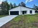Charming single-story home features a black garage door and a well-manicured lawn at 3063 Sw 168Th Loop, Ocala, FL 34473