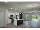 Open-concept kitchen with stainless steel appliances and an eat-in center island at 3063 Sw 168Th Loop, Ocala, FL 34473