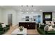 Bright, open-concept living room featuring a modern kitchen with stainless steel appliances and pendant lighting at 3063 Sw 168Th Loop, Ocala, FL 34473