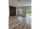 A spacious living room features new floors, a window, and a unique wall design at 3063 Sw 168Th Loop, Ocala, FL 34473