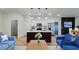 Bright, open-concept living room featuring a modern kitchen with stainless steel appliances and pendant lighting at 3063 Sw 168Th Loop, Ocala, FL 34473