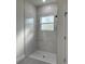 A new shower featuring marble look tile and hexagon tile flooring at 3063 Sw 168Th Loop, Ocala, FL 34473