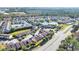 Wide aerial view of a condo community with a lake, pool, and surrounding woodlands at 3157 Britannia Blvd # B, Kissimmee, FL 34747