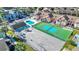 Aerial view shows a playground, tennis court, pool, and colorful condo community at 3157 Britannia Blvd # B, Kissimmee, FL 34747