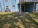 Exterior view of a backyard featuring a lawn and patio, with air conditioning units at 3157 Britannia Blvd # B, Kissimmee, FL 34747