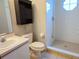 Bathroom featuring white sink, toilet, and shower stall with octagon window at 3157 Britannia Blvd # B, Kissimmee, FL 34747