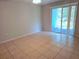 Bright bedroom with tile floors and sliding glass doors to private patio at 3157 Britannia Blvd # B, Kissimmee, FL 34747