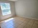 Bedroom features a window with tiled floor at 3157 Britannia Blvd # B, Kissimmee, FL 34747