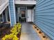 Inviting condo entryway with well-manicured landscaping and a freshly painted door at 3157 Britannia Blvd # B, Kissimmee, FL 34747