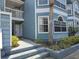 Attractive condo exterior with blue siding, well-maintained landscaping and private entry at 3157 Britannia Blvd # B, Kissimmee, FL 34747