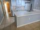 Functional kitchen featuring white cabinets, laminate countertops, and modern appliances at 3157 Britannia Blvd # B, Kissimmee, FL 34747