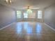 Spacious living room featuring neutral paint, tile flooring, and large windows for natural light at 3157 Britannia Blvd # B, Kissimmee, FL 34747