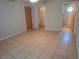 Large main bedroom with tile flooring leading into the bathroom with standing shower at 3157 Britannia Blvd # B, Kissimmee, FL 34747
