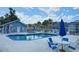Community pool with ample seating and a blue pergola offers a refreshing outdoor space at 3157 Britannia Blvd # B, Kissimmee, FL 34747