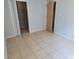 Room with neutral walls and tiled flooring leading to closet and doorway at 3157 Britannia Blvd # B, Kissimmee, FL 34747