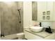 Modern bathroom features a stylish sink, dark hardware, and a walk-in shower with decorative neutral tiling at 346 Bowfin Ct, Kissimmee, FL 34759