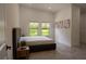 Serene bedroom with large windows, modern decor, and a comfortable bed at 346 Bowfin Ct, Kissimmee, FL 34759