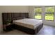 Comfortable bedroom features two windows, modern decor and a cozy bed at 346 Bowfin Ct, Kissimmee, FL 34759