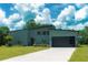 Modern home with a well-kept lawn, a sleek garage door, and contemporary architectural details at 346 Bowfin Ct, Kissimmee, FL 34759