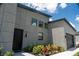 Modern home exterior with a well-manicured lawn and garden, a sleek front door, and modern garage door at 346 Bowfin Ct, Kissimmee, FL 34759