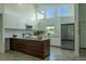 Stylish kitchen boasting a kitchen island, stainless steel appliances, and ample natural light at 346 Bowfin Ct, Kissimmee, FL 34759