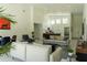 Bright, open-concept living room with high ceilings and modern furniture flows seamlessly into the kitchen at 346 Bowfin Ct, Kissimmee, FL 34759