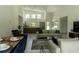 Bright, open-concept living room features a dining area, modern furniture, and large windows for natural light at 346 Bowfin Ct, Kissimmee, FL 34759