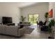 Open-concept living room with natural light and a view of the outdoors at 346 Bowfin Ct, Kissimmee, FL 34759