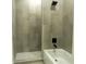 Tiled shower and tub combo featuring neutral tiles and modern fixtures at 346 Bowfin Ct, Kissimmee, FL 34759