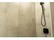 Close-up of tiled shower with modern fixtures and a handheld shower head at 346 Bowfin Ct, Kissimmee, FL 34759