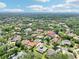 A wide aerial view of a neighborhood with mature trees and lush landscapes at 356 N Spaulding Cv, Lake Mary, FL 32746