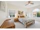 Comfortable bedroom with natural light, ceiling fan, neutral color palette and windows with charming arched top at 356 N Spaulding Cv, Lake Mary, FL 32746